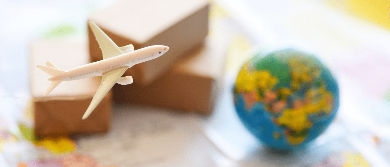 close-up photo of a toy airplane and a planet earth